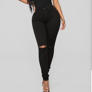 Black skinny jeans with knee slit
